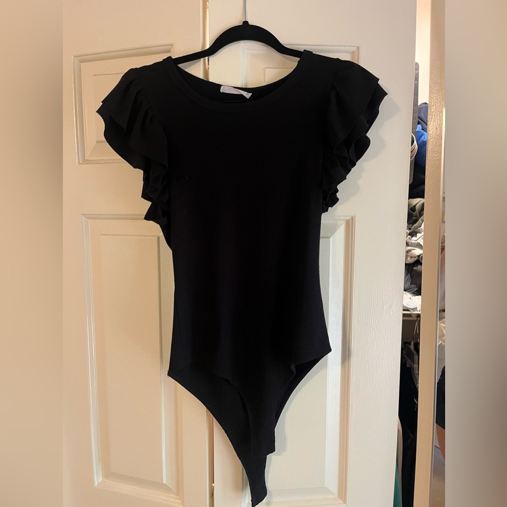 Super cute Wasabi + Mint short sleeve black body suit with ruffle sleeves.